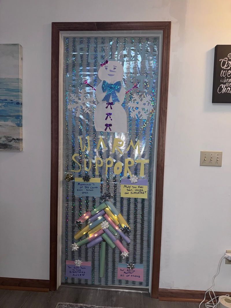 Office door decorated Feeling Frosty, Warm Support, with a snowman and notes reading you don't have to hold everything alone