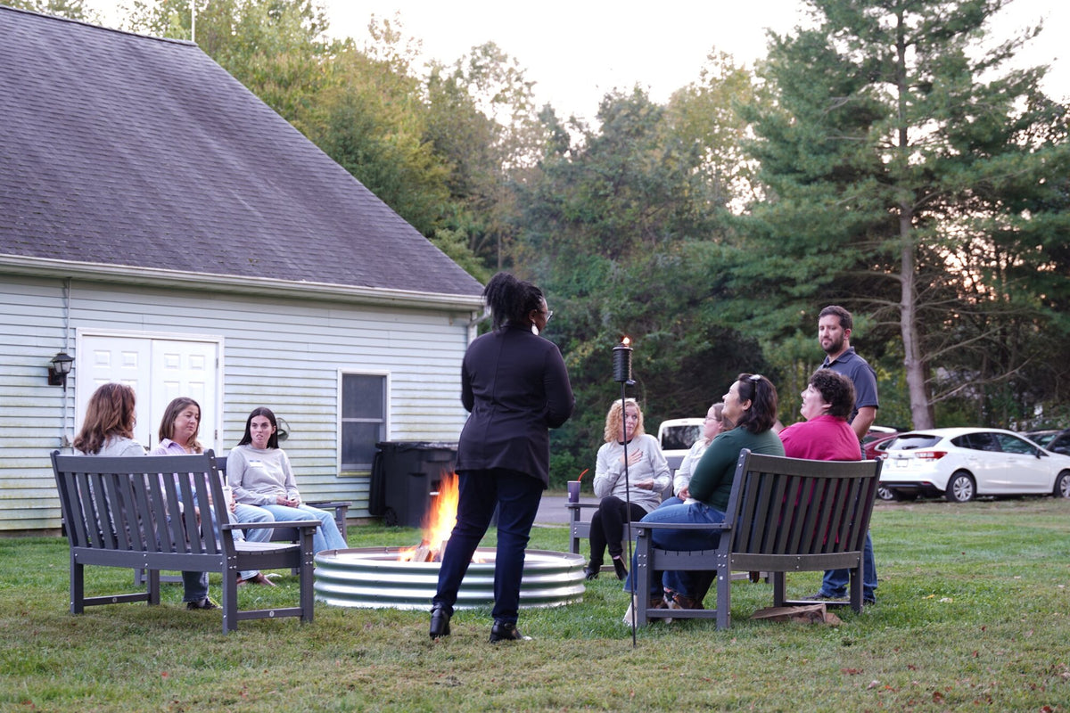 Mental health providers gathered around a fire pit on the Center for Balanced Living lawn