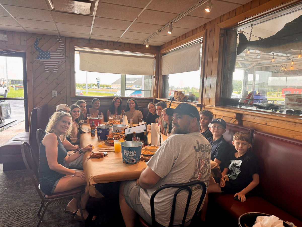 Staff and families gathered around a long table at Meding's Seafood