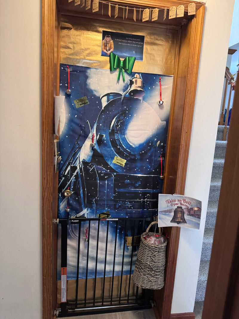 Office door decorated as the Polar Express, with jingle bells and a basket of bells to take