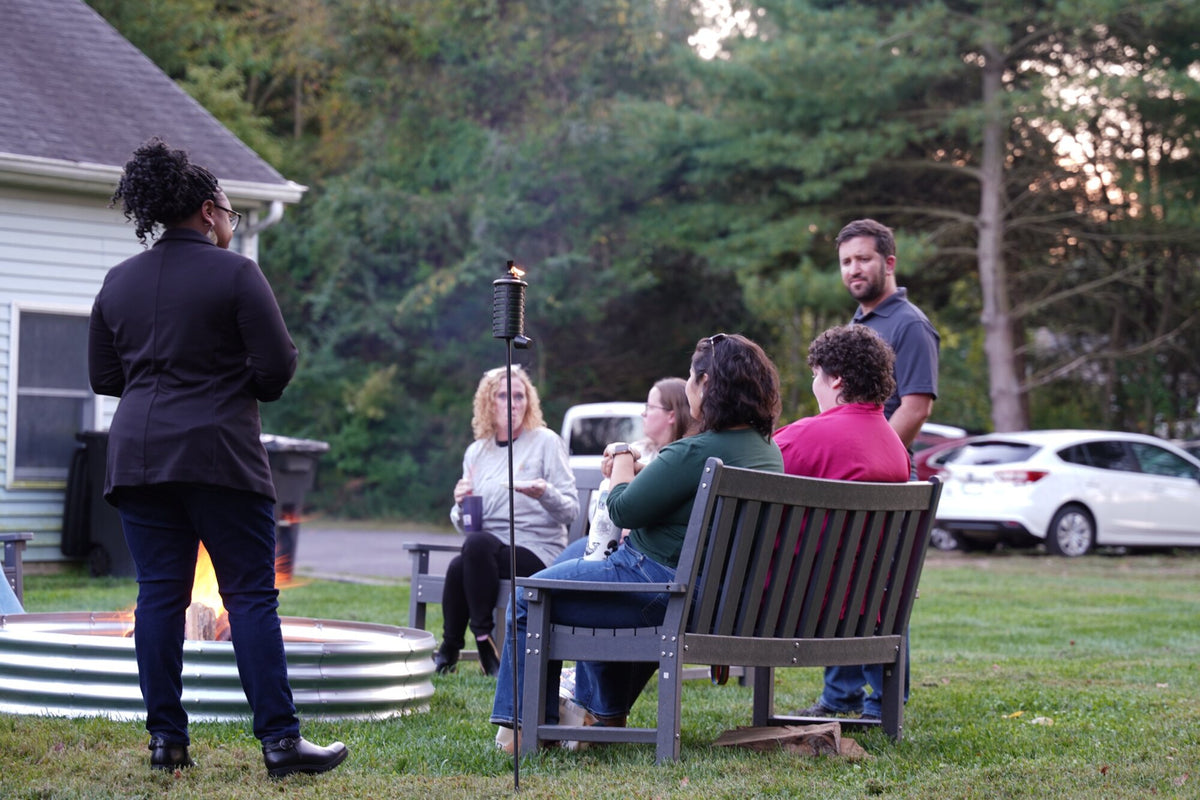 Providers by the fire at dusk on the Townsend property